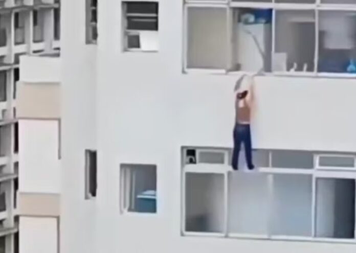 VÍDEO: Mulher escorrega e fica pendurada em prédio ao tentar limpar janela